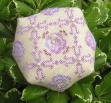 Pearl glass beads used in a cross stitch design